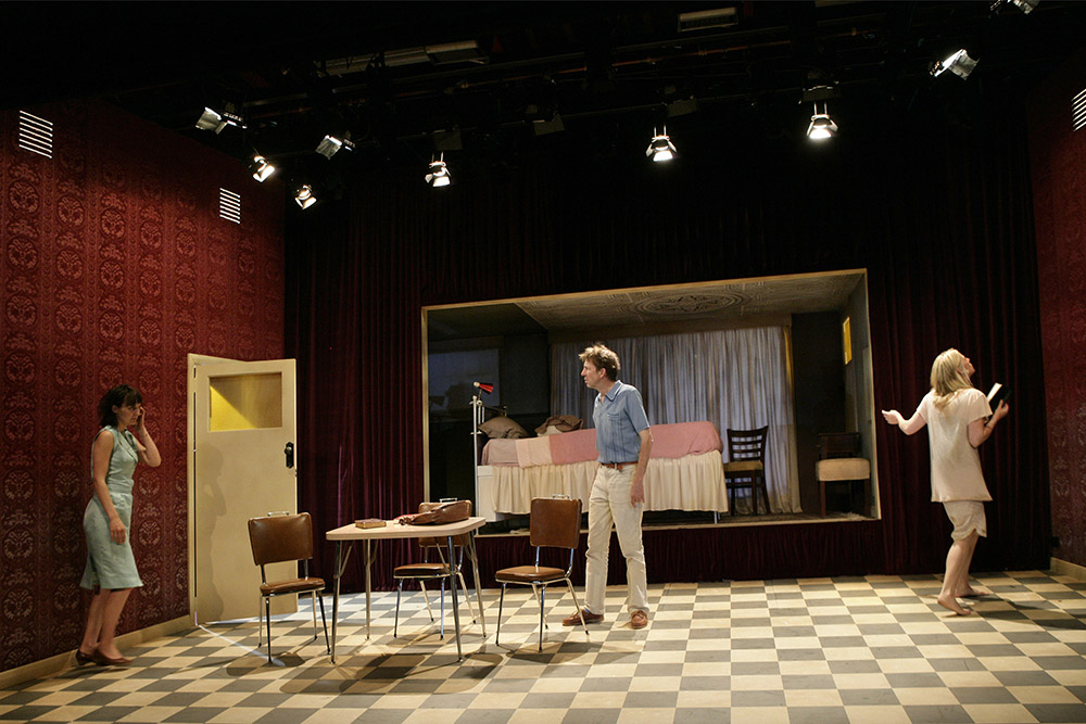 Production still for "Furious Mattress". L-R: Rita Kalnejais as Anna, Robert Menzies as Pierce, Kate Kendall as Else. Photographer: Jeff Busby