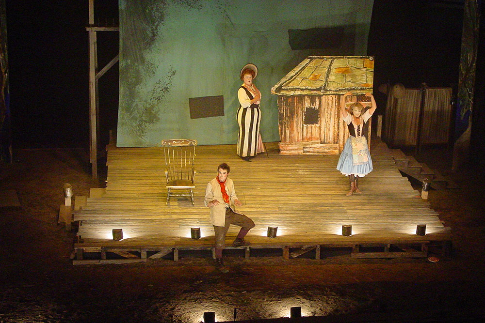 Production still for "Babes in the Wood" (2003). L-R: Eddie Perfect as Jack, Max Gillies as Aunty Avaricia, Diana Emry as Phyllis. Photographer: Anna Tregloan