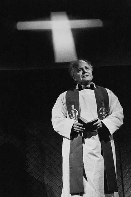 Production still from "The Freedom of the City". Robin Cuming as the Priest. Photographer: Jeff Busby