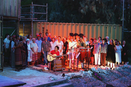 Production still for "Mavis Goes to Timor". The Mavis Goes to Timor Community Choir, with musicians. Photographer: Jon Green