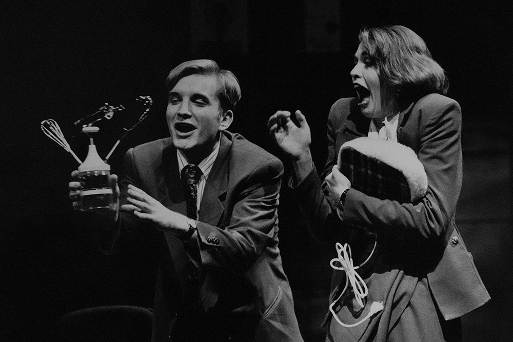 Production still for "The Adman". L-R: Ben Grant as Rhys Burns, Nadja Kostich as Leah Blonskey. Photographer: Jeff Busby