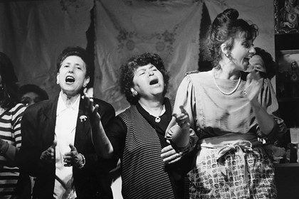 Production still for "Emma: Celebrazione!" Laura Lattuada (far right), with members of the choir. Photographer: Jeff Busby